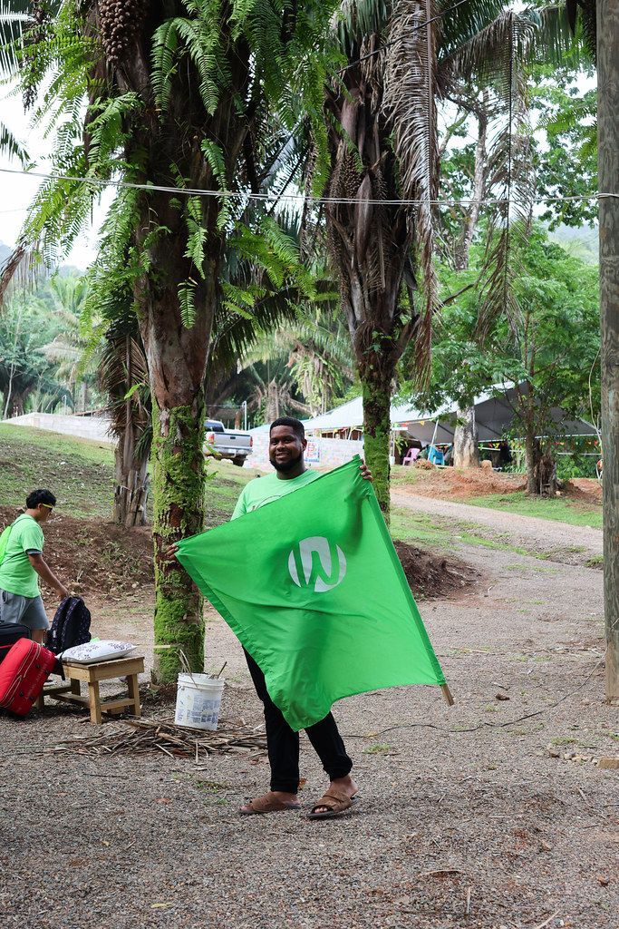 Junior camper waving the team flag