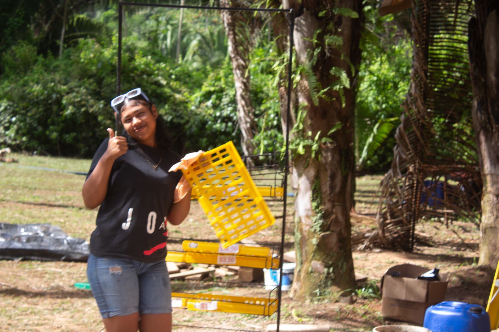 Camp Crew youth holding a yellow crate on the grounds