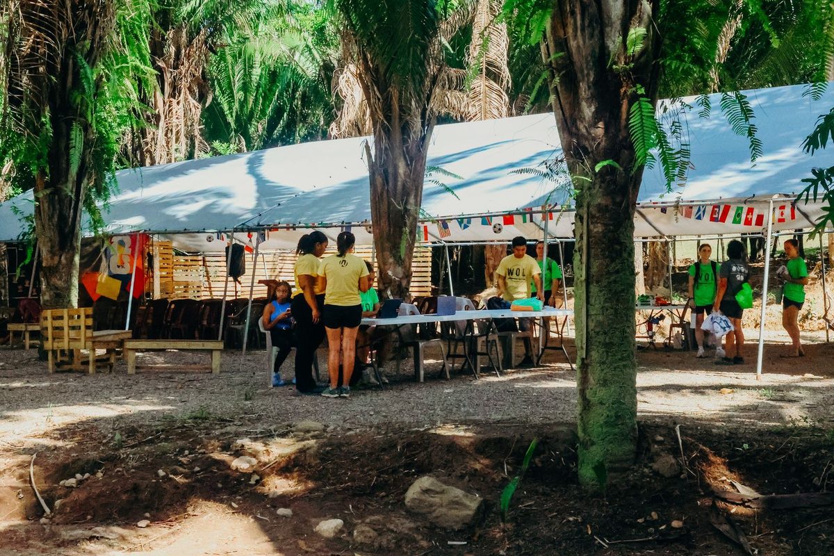 Tent pavilions and tables under the trees at The Peak