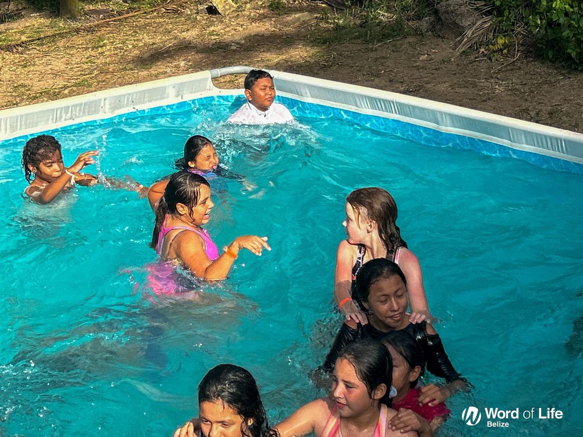 Children swimming and playing in the camp pool