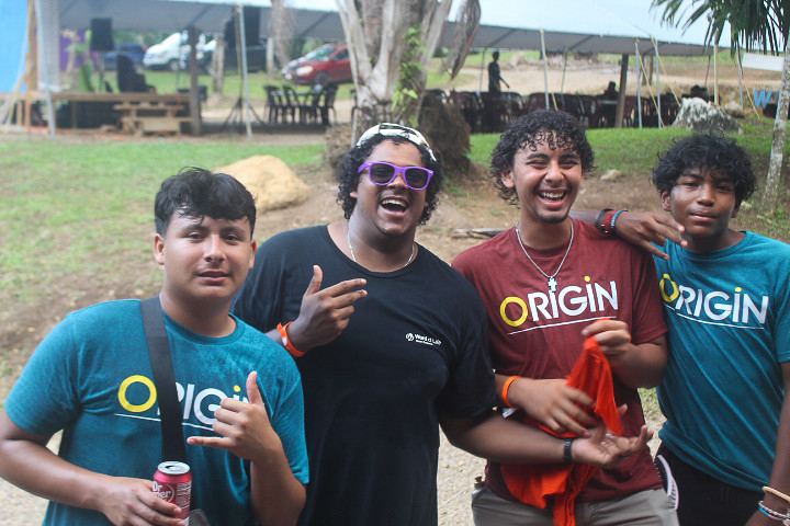 Four teens laughing together at camp