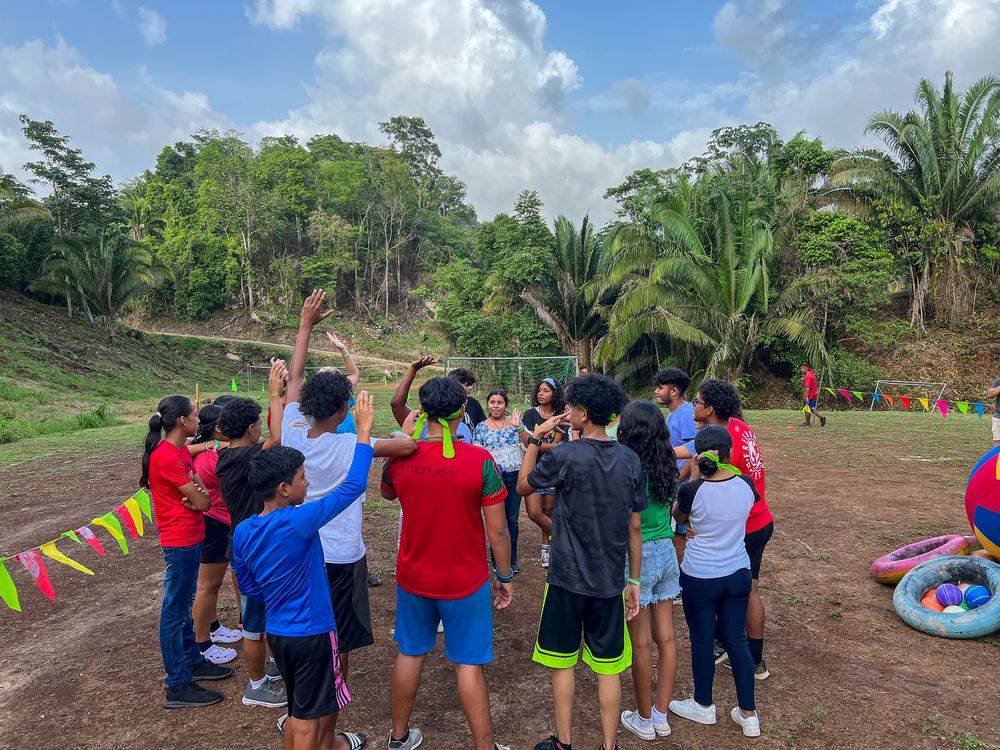 Teen campers together on the field