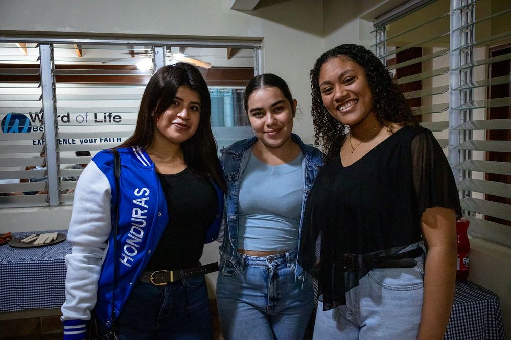 Three young women smiling together